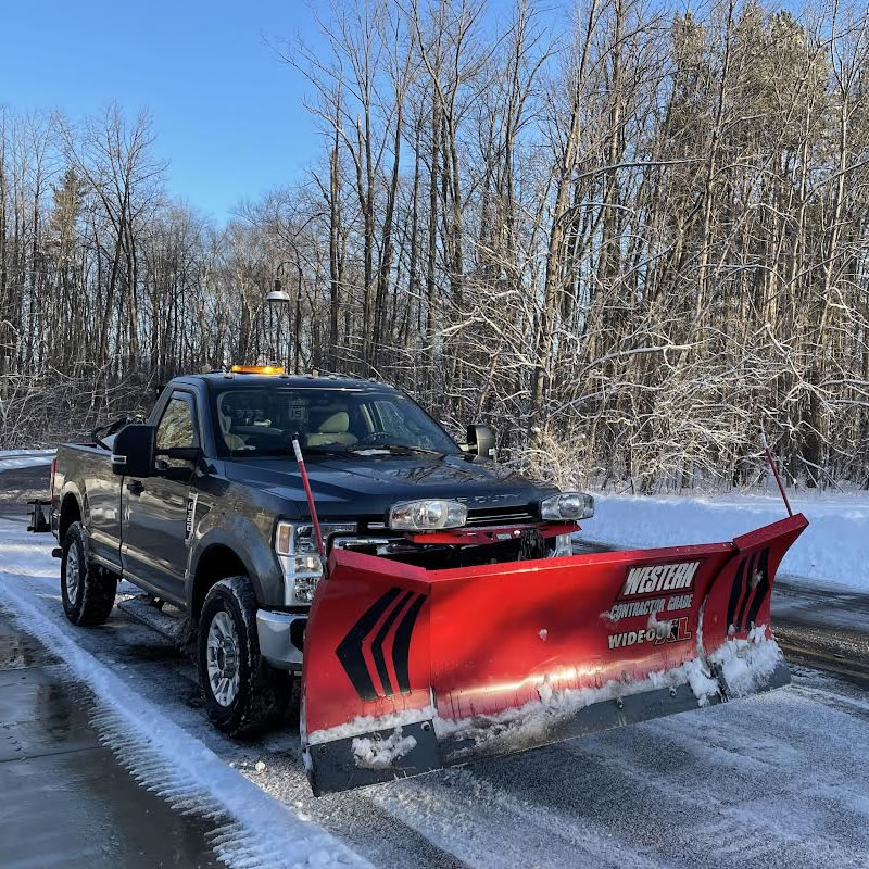 Contek snowplow truck clearing a snowy roadway